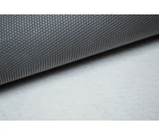 Carpet — close-up of a carpet roll with a perforated underside.