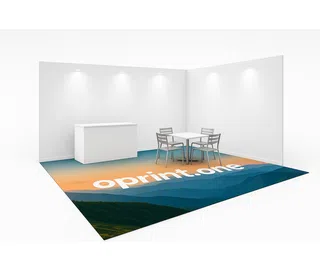 Trade show booth with white furniture, featuring a promotional carpet on the floor with a mountain landscape print in shades of blue and orange, and white text reading “oprint.one.”