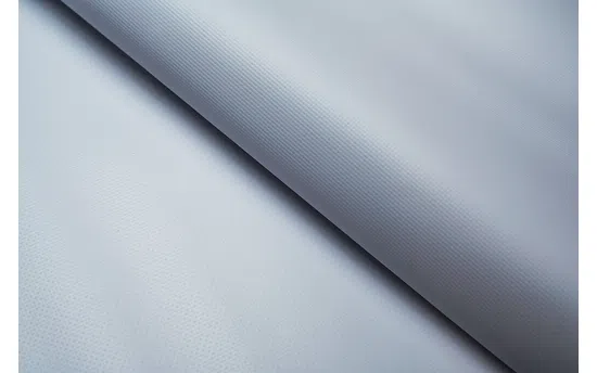 Close-up of white Frontlit Standard 450g material arranged in soft, diagonal folds.