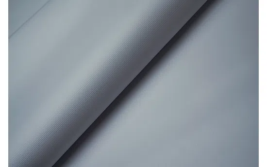 Close-up of white Frontlit Standard 450g material arranged in soft, diagonal folds.