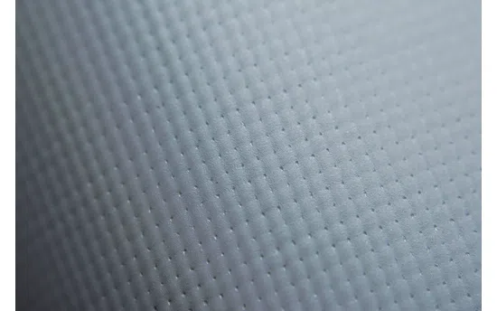 Close-up of white Frontlit Standard 450g material arranged in soft, diagonal folds.